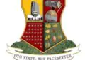 Oyo State coat of arms: four-quadrant shield with a monument, a drum, stars, and crops; motto reads 'OYO STATE: THE PACES...'.